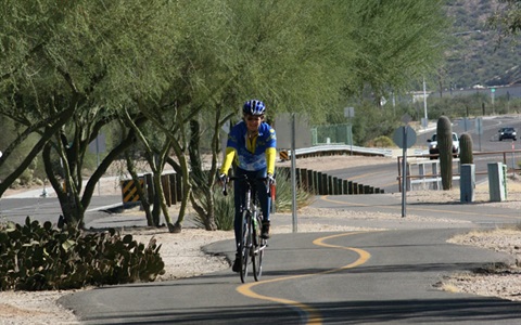 Bicyclist riding on a paved path