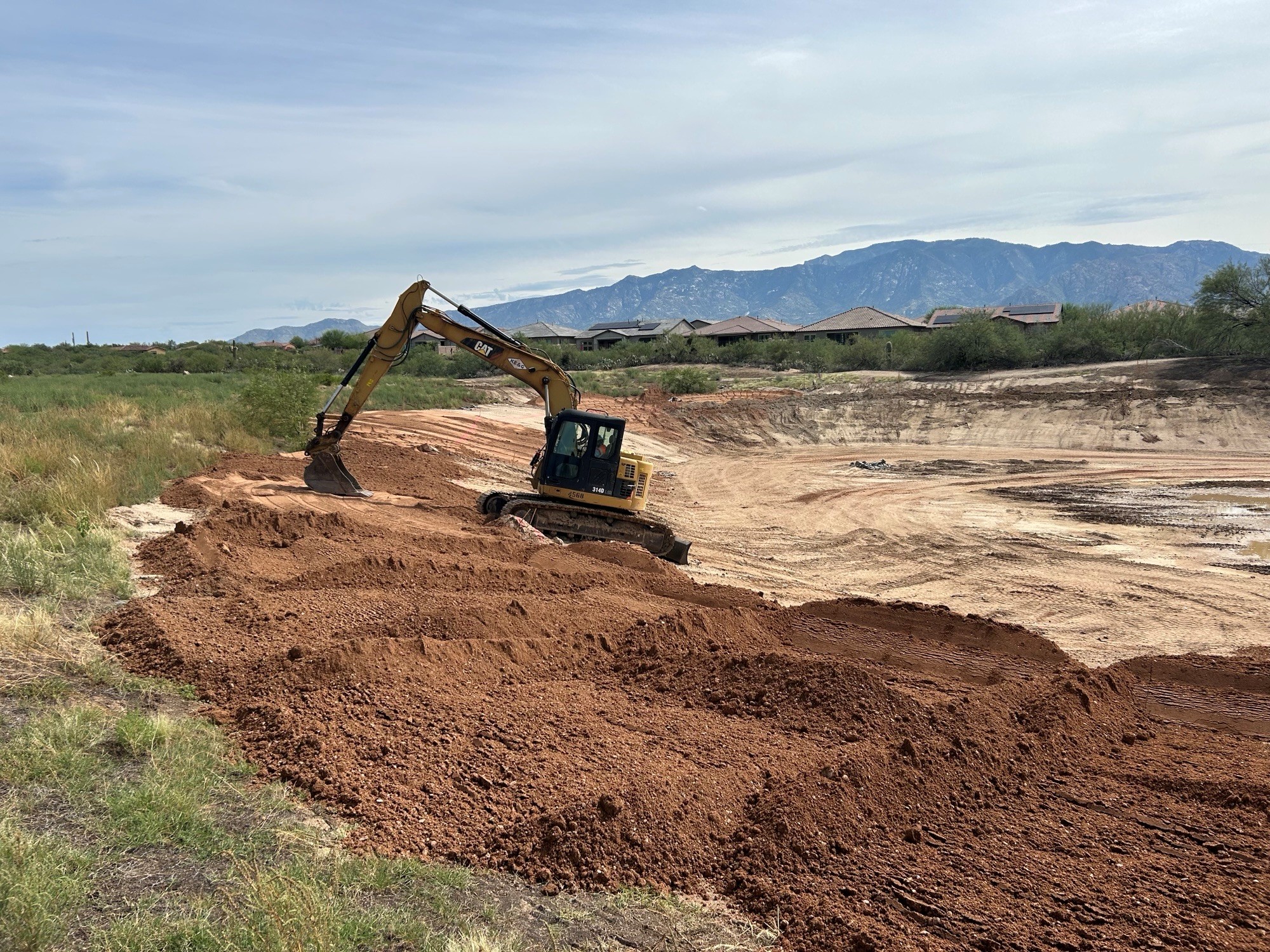 Grading compacting of the pond